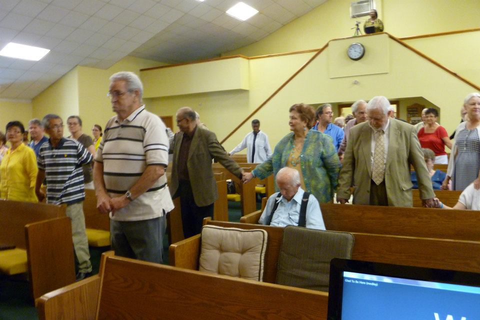 Congregation members standing together in worship