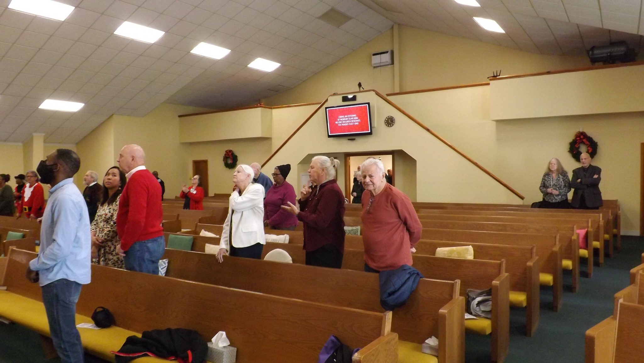 Older congregation members gathered in worship representing senior fellowship